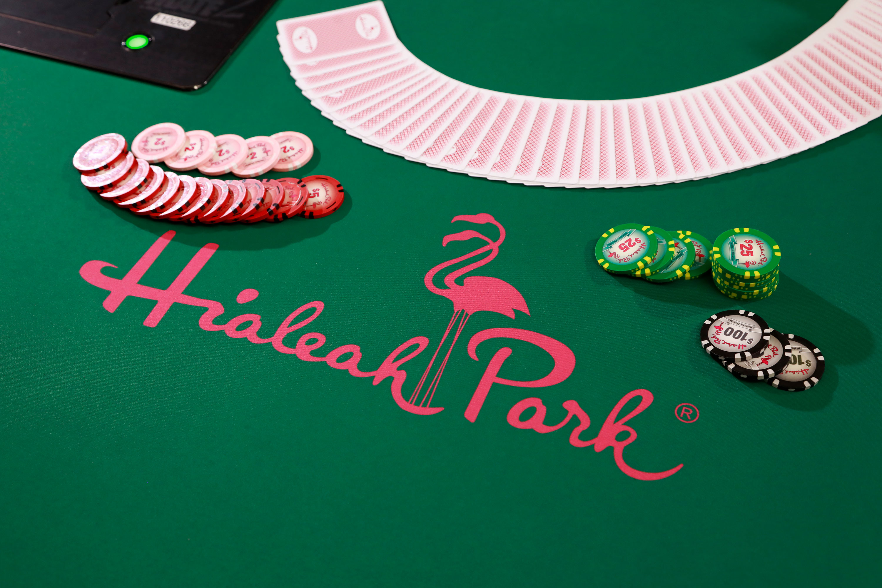 Poker table with playing cards and chips